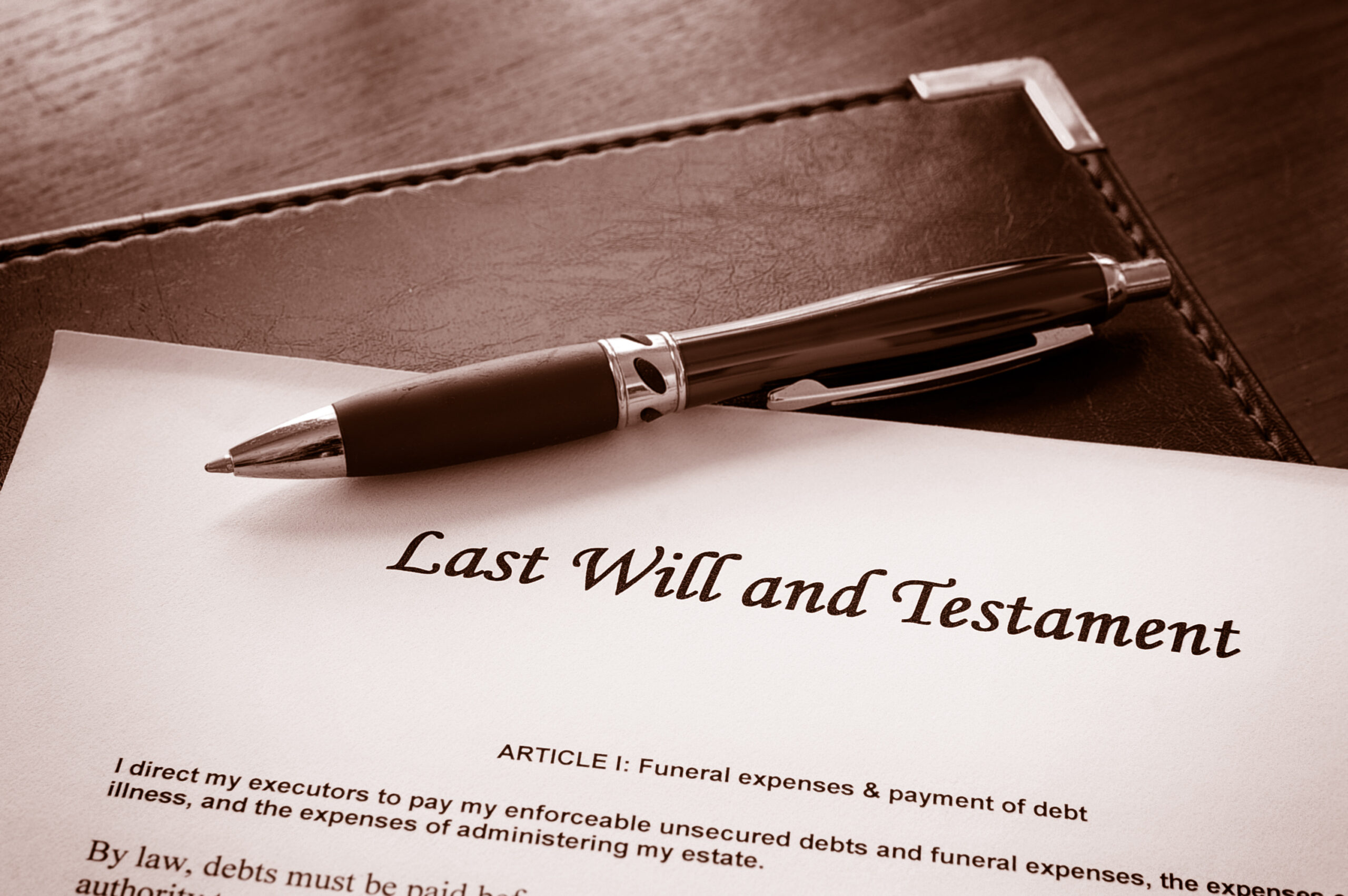A paper with the text Last Will and Testament, with a pen on top